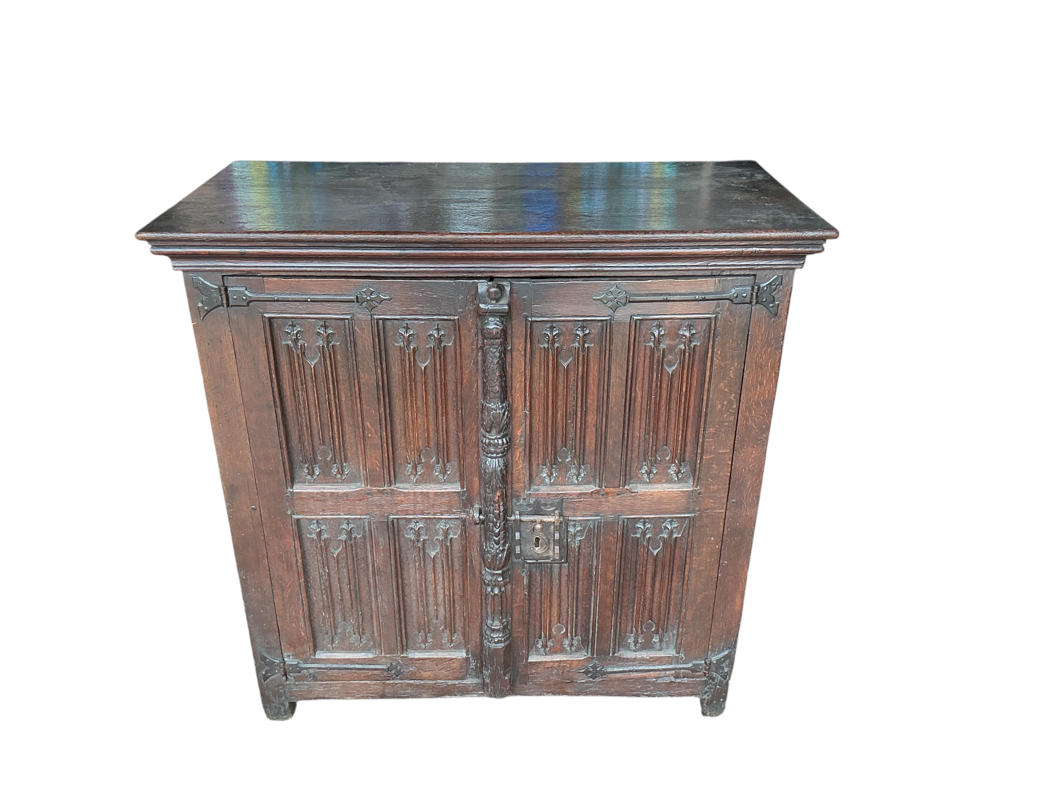 An 18th century and later French carved oak two door cabinet, width 115cm, depth 53cm, height 115cm